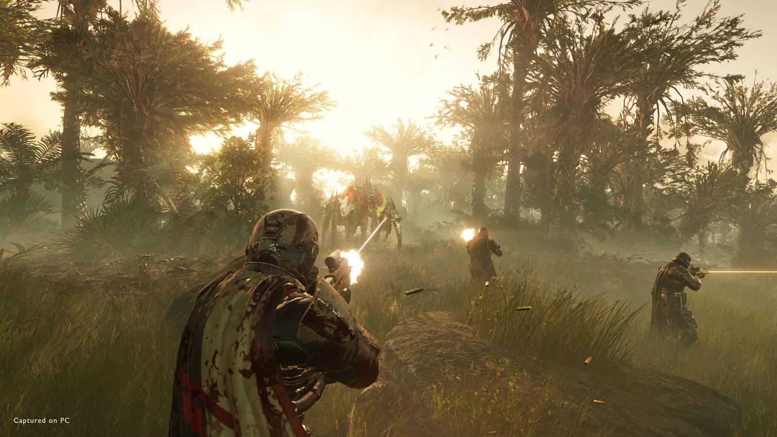 Helldivers 2 squad in blood-spattered capes firing rifles at a giant Terminid bug in a misty jungle