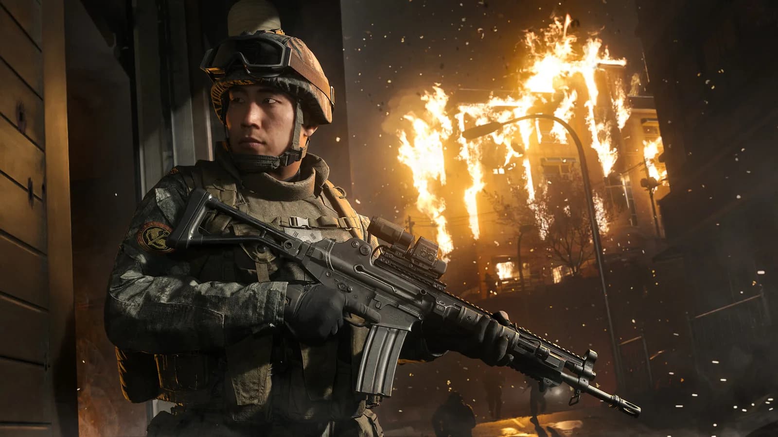 Call of Duty: Modern Warfare 4 soldier in a helmet and goggles holds a rifle beside a burning building at night