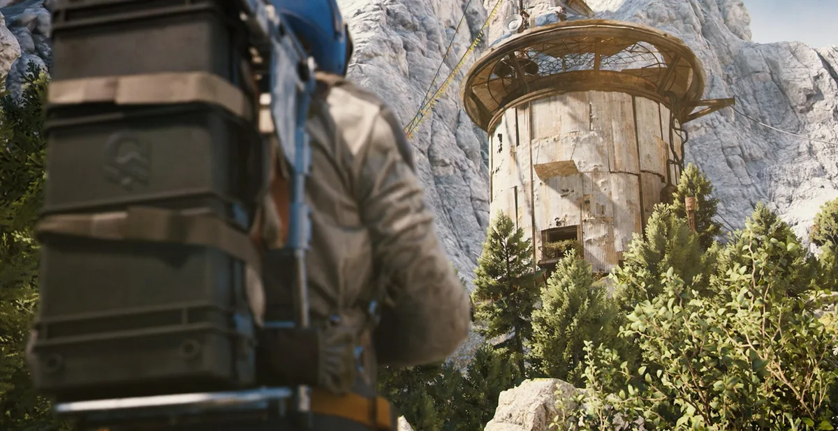 Weathered corrugated tower on a rocky mountainside in ARC Raiders, with a Raider in a blue helmet carrying a heavy backpack in the foreground