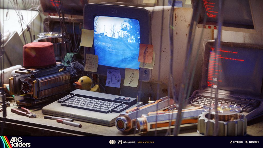 Official ARC Raiders Phantom Targets promotional still: a cluttered workbench with a CRT monitor displaying a grainy surveillance photo of a watchtower, surrounded by sticky notes and salvaged tools