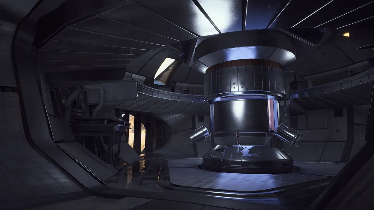 Interior of the Harvester, a dark metal chamber with a large central pillar and two fusion core slots at its base