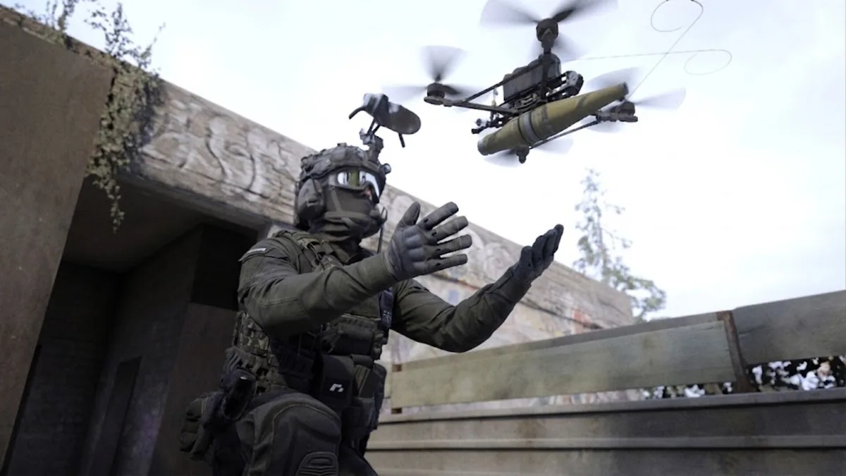 Bodycam operator in tactical gear launching a small explosive-carrying reconnaissance drone against a graffiti-marked concrete wall