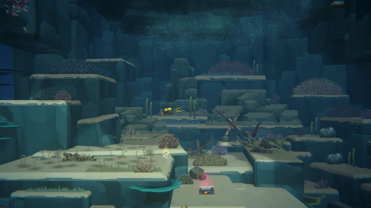 Dave in a yellow diving suit swimming through a sunken shipwreck site scattered across rocky underwater ledges, with a glowing treasure chest and coral growth visible below