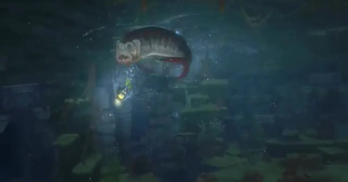 A diver's headlamp illuminates a large ancient predatory fish with a wide toothed mouth in dark, moss-covered underwater ruins