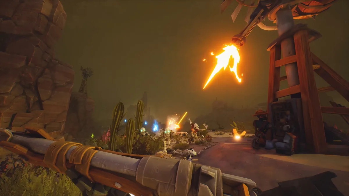 Far Far West first-person combat in a hazy desert canyon at dusk, a bright orange fire spell effect burning above cactus plants near a distant windmill, with skeletal enemies advancing along a dirt path