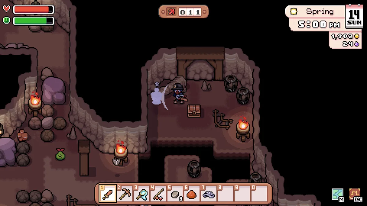 Player fighting a translucent ghost enemy with a sword inside a torch-lit cave, health and stamina bars visible in the HUD