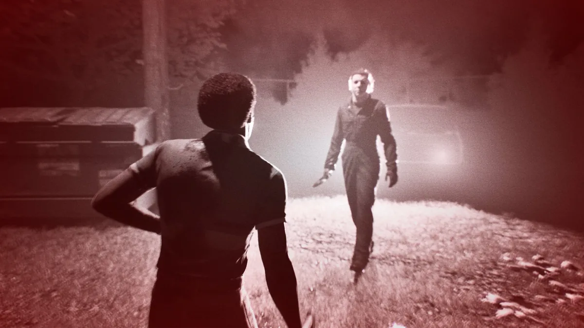 A survivor standing in a foggy red-lit yard watching Michael Myers slowly approach with a knife