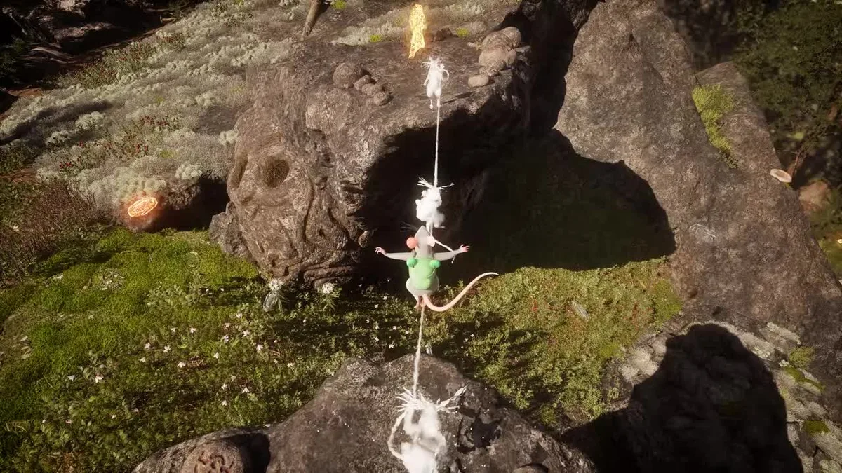 A mouse with a green frog backpack balances on a rope strung between two pale ghostly mouse copies on mossy rocks