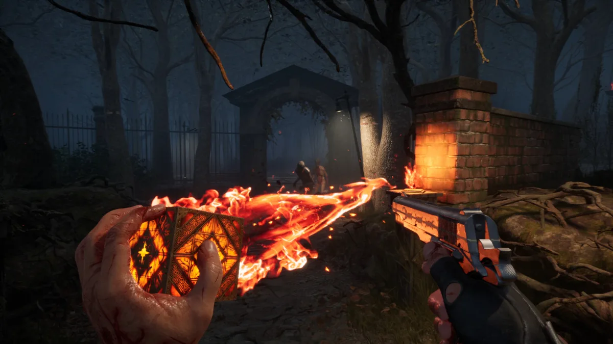 Burning Genesis Configuration puzzle box held in the left hand while the right hand aims a pistol through a foggy graveyard