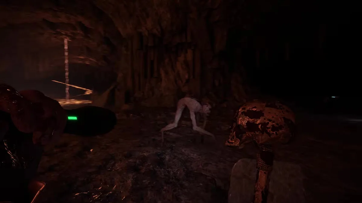 Dark cave lit by a torch, a pale crawling mutant beside a skull totem
