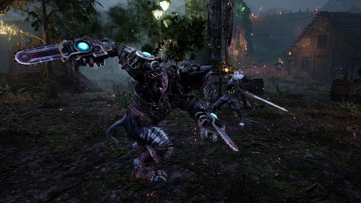 Kristala large chainsaw rat enemy rearing up with both arms raised in a dark village camp, player visible in the background
