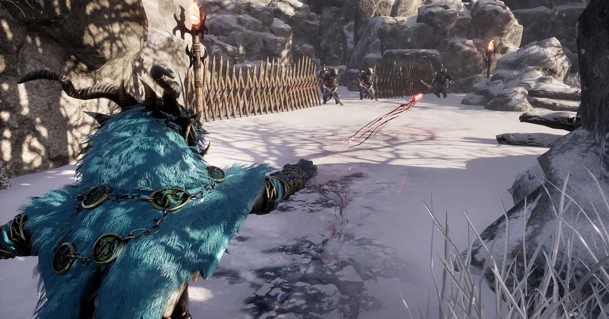Kristala feline warrior in a blue cloak facing armored enemies across an open snowy arena with torch-lit fences