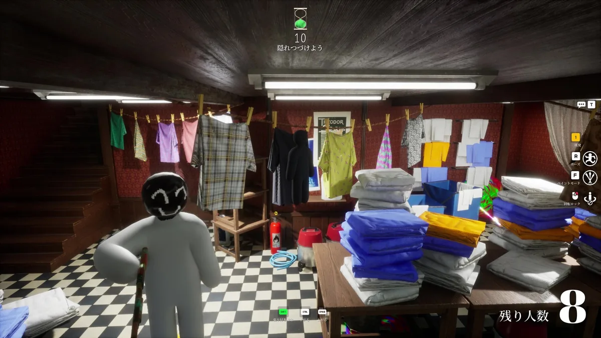 Meccha Chameleon Hider disguised in a dim laundry room among hanging clothes and folded towel stacks, a fire extinguisher and cleaning supplies nearby