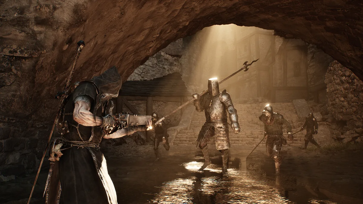 A hooded figure confronts a group of polearm-wielding armored soldiers in a sunlit stone tunnel leading toward a hazy ruined town