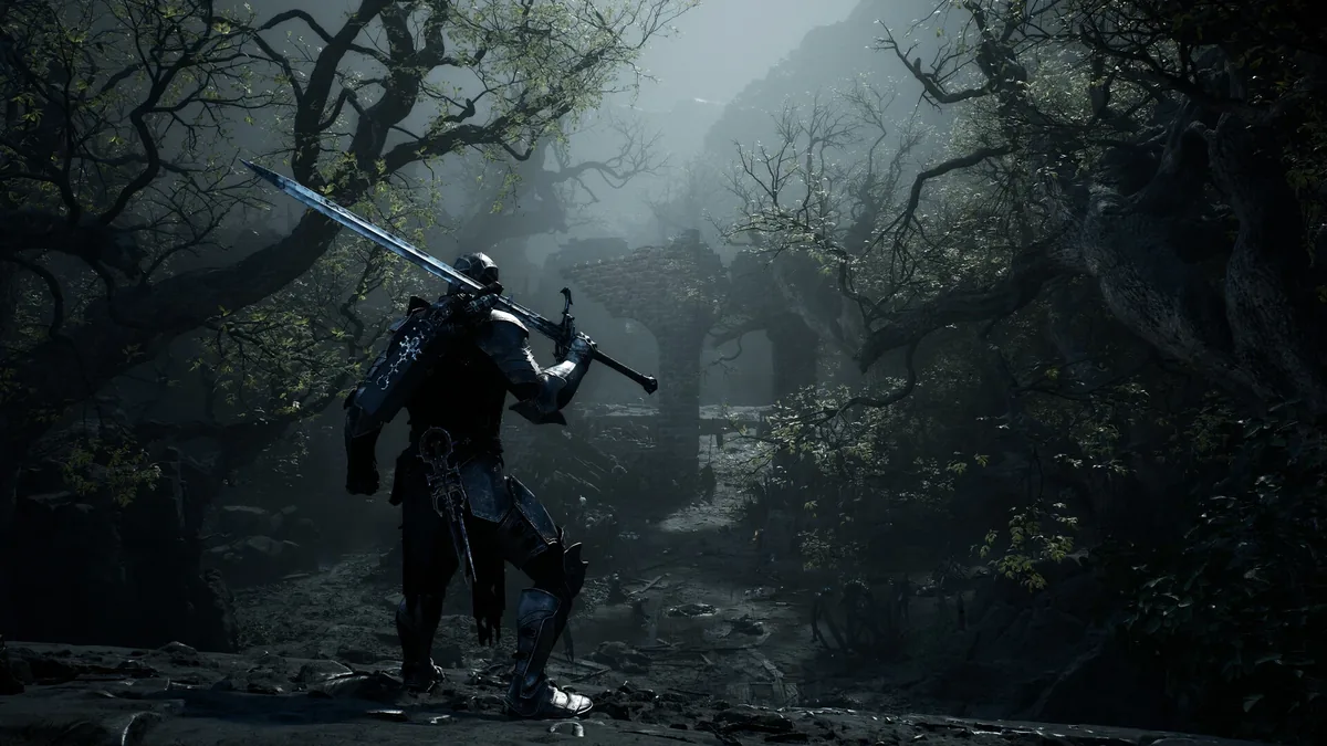 A knight in dark ornate armor carries a large sword slung over one shoulder while walking through a misty forest ruin