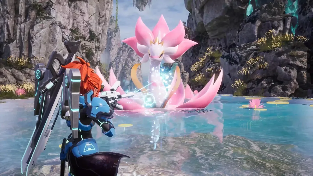 A player character in blue armor stands over a pink flower-shaped Pal releasing an energy burst in a rocky river channel