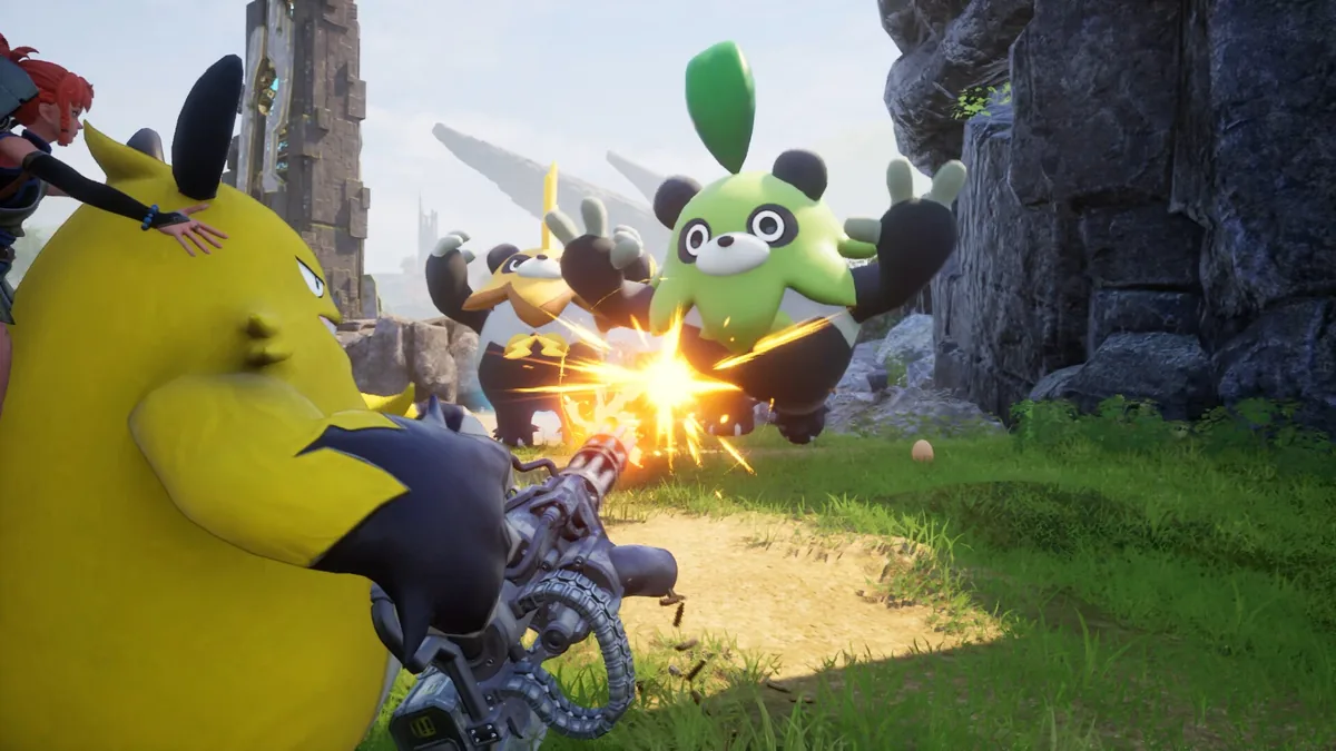 A player riding a large yellow Pal fires a mounted minigun at two panda-like green and yellow Pals near a stone ruin