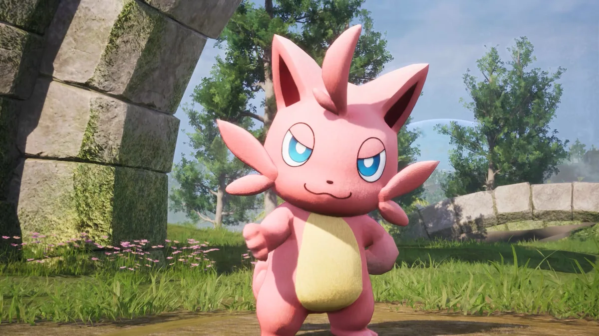 A small pink fox-like Pal with tufted ears and a yellow belly stands near stone ruins and pink wildflowers