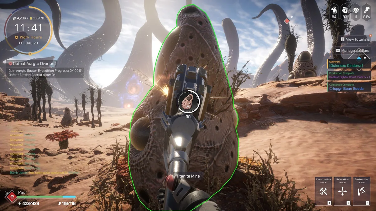 First-person view mining a glowing alien creature-like rock formation labeled Titanite Mine in a desert field, with a Defeat Auryto Overlord quest tracker and an Overwork alert visible