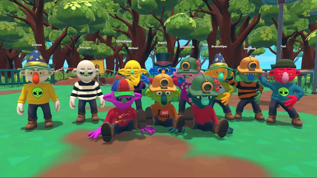 A crowd of about a dozen Pratfall characters in mixed costumes and hats gathered on the grass of the dog park