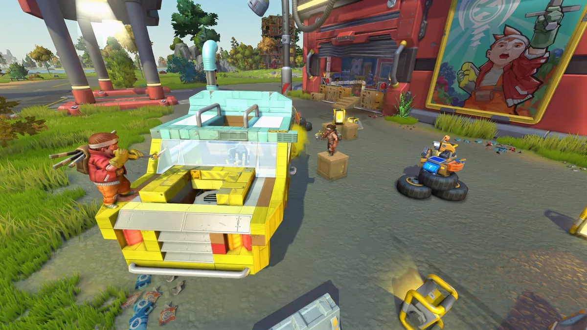 A player-built open-top buggy with visible bearing-driven wheels parked outside a red garage building, a small hover-drone riding on its own set of tires nearby