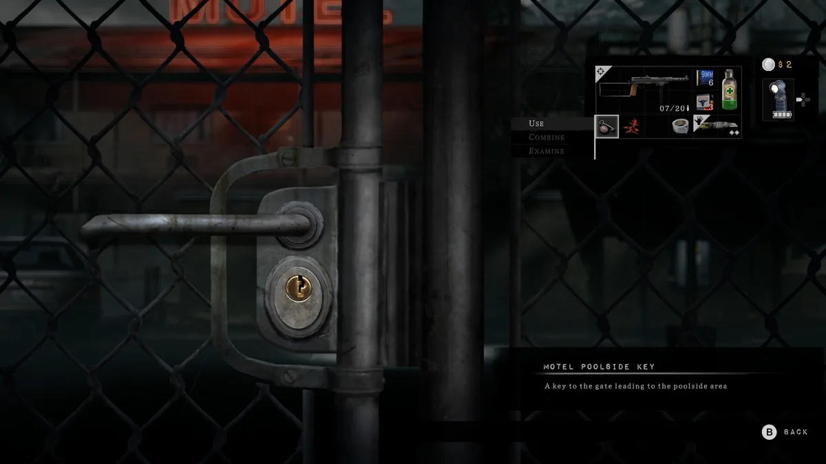 A chain-link gate with a padlocked handle in front of a motel sign, with an inventory panel describing the Hotel Poolside Key