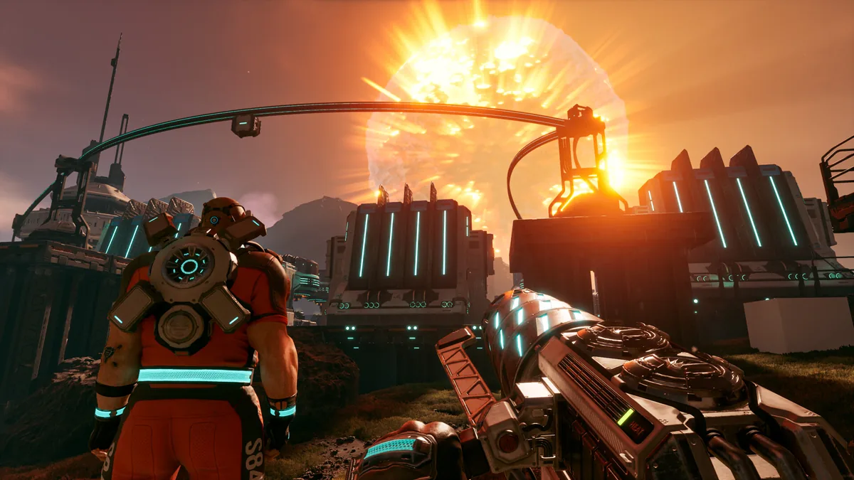 A player in an orange survival suit watches a massive solar flare erupt above their industrial base, linked by an overhead rail line