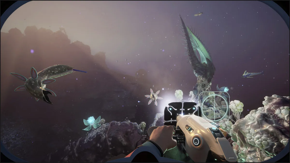 Subnautica 2 diver aims a tool at large alien creatures in a dark cavern