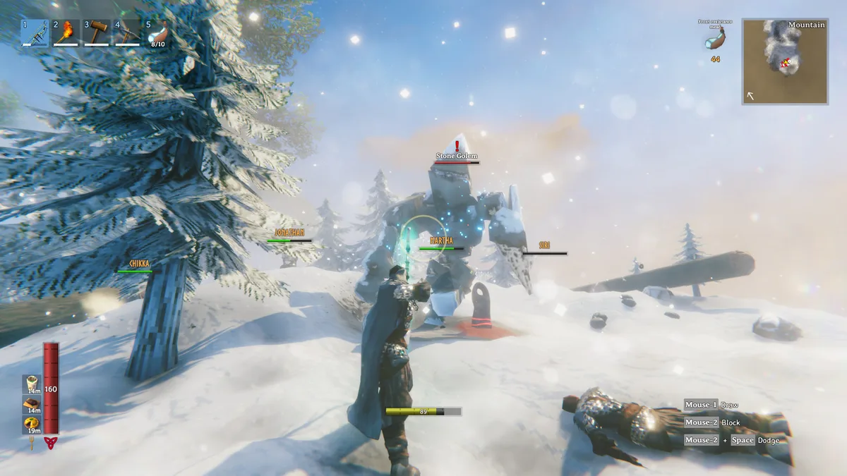 Valheim player fighting a Stone Golem in a snowy Mountain biome with the combat interface and co-op teammates' names visible