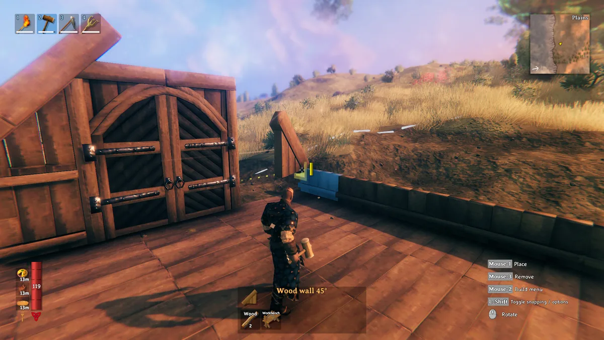 A player in dark armor stands on a wooden deck placing a wall piece next to a large wooden gate, with grassy Plains hills and a minimap labeled Plains visible