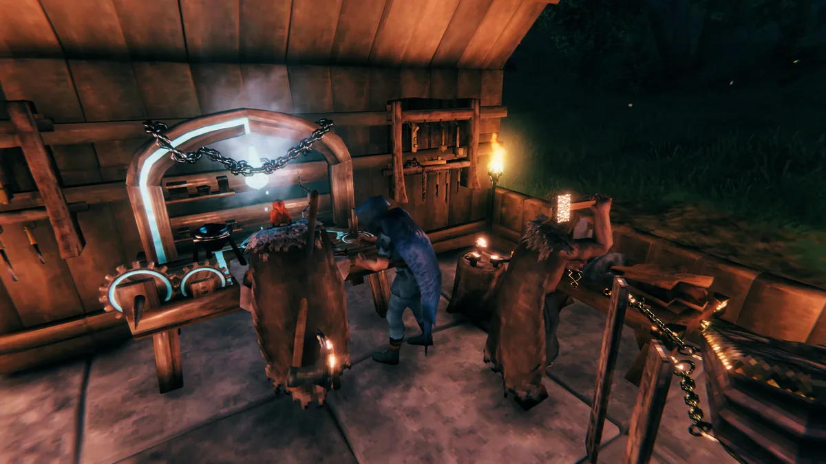 A player crafts at a glowing arched forge station inside a wooden workshop at night, with a red bird perched nearby and torches lighting the room