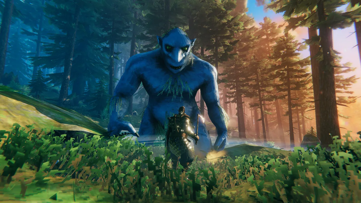Player confronting a towering blue Forest Troll in Valheim's Black Forest biome, weapon drawn at close range