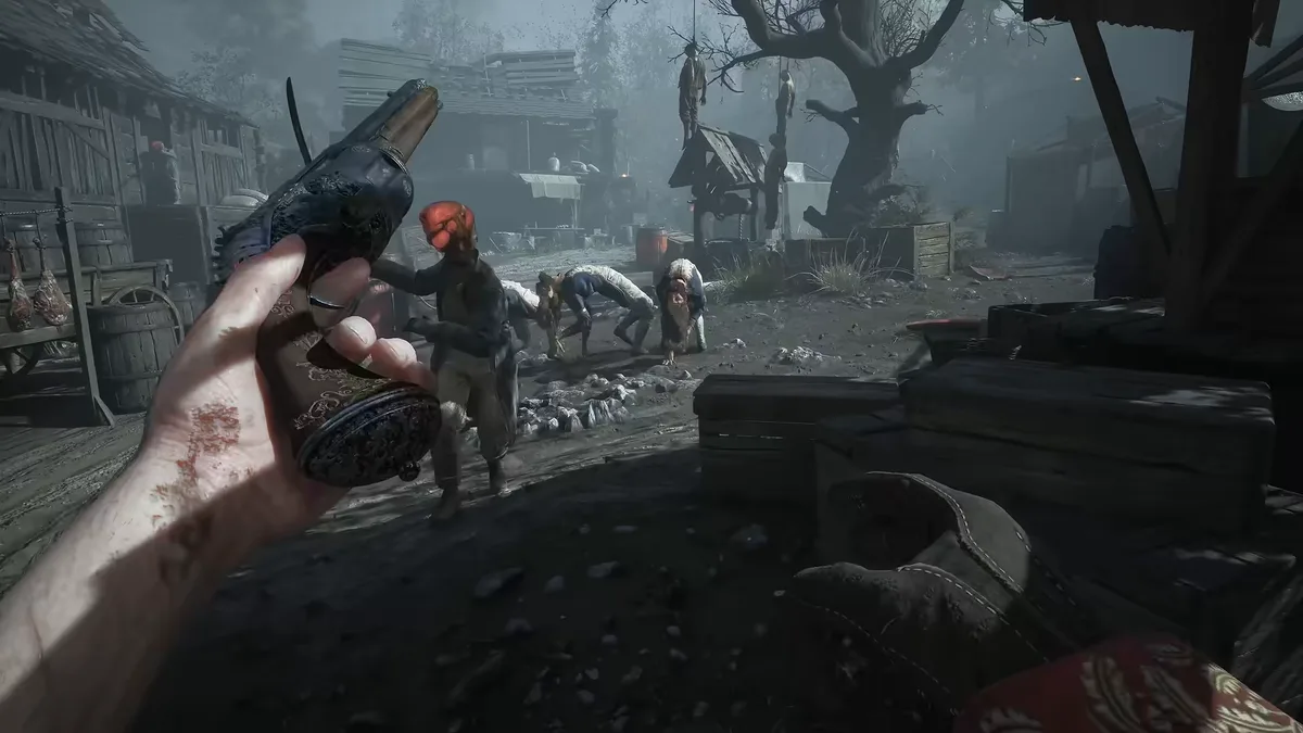 First-person view holding a flintlock pistol over a muddy village street where hunched figures kneel in the distance