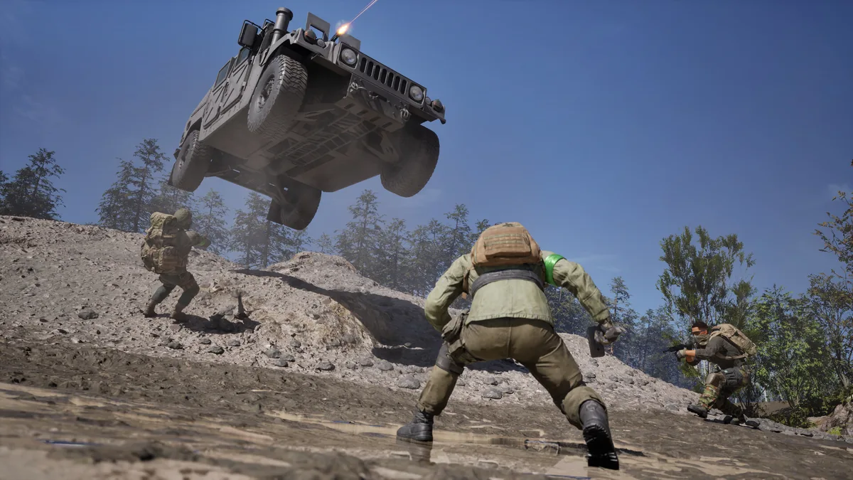 An armored Humvee fires its mounted weapon while airborne over rocky terrain as three squad members engage targets on a hillside below