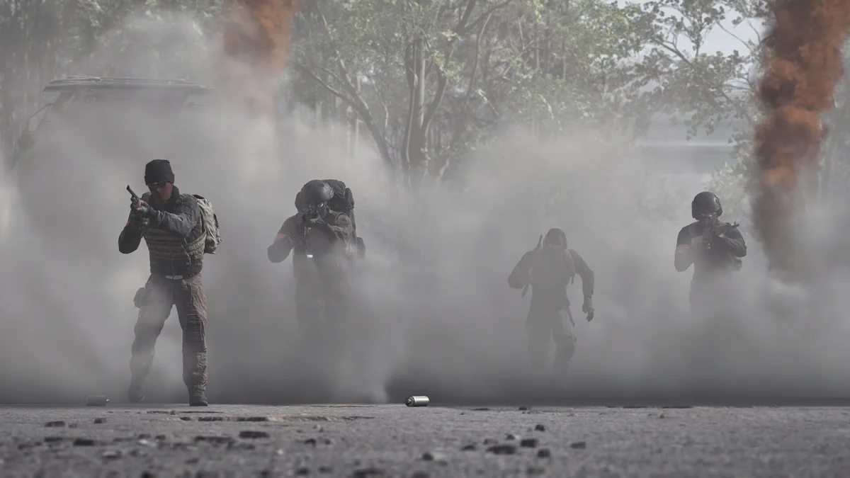 Four soldiers advance through thick grey and orange smoke on a paved road, with a downed vehicle visible in the background