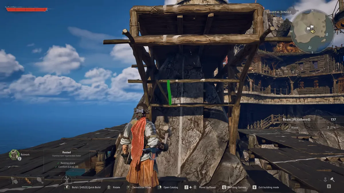Windrose player in build mode placing a weathered beam on a wooden frame around a rock pillar, a multi-level wooden base on the cliff behind