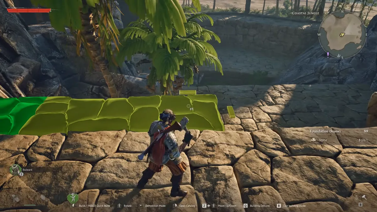 Windrose player in build mode placing a stone foundation along a ruined Coastal Jungle wall, the piece highlighted green with its stone cost shown